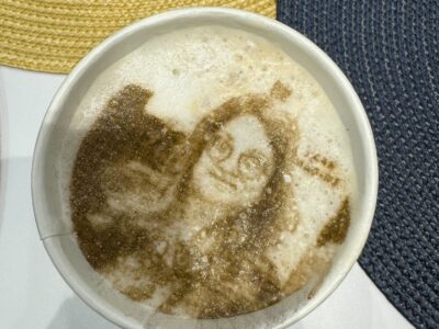 An image of a woman in a latte mug.